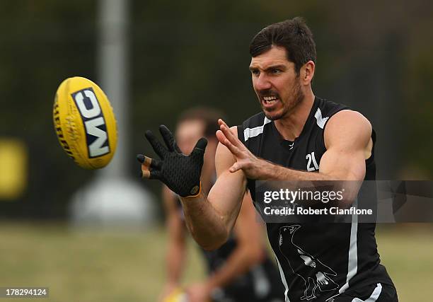 Quinten Lynch of the Magpies takes the ball during a Collingwood Magpies AFL training session at Olympic Park on August 29, 2013 in Melbourne,...