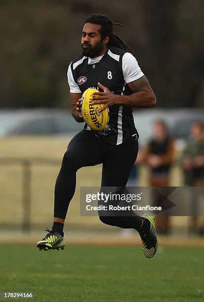 Heritier O'Brien of the Magpies takes the ball during a Collingwood Magpies AFL training session at Olympic Park on August 29, 2013 in Melbourne,...