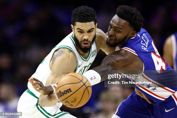 Jayson Tatum of the Boston Celtics and Paul Reed of the Philadelphia 76ers challenge for the ball during the second quarter at the Wells Fargo Center...