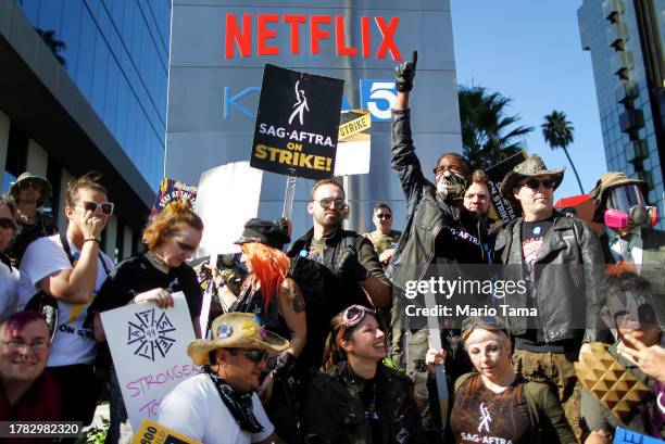 Members pose for a group photo, during a 'Post Apocalyptic' themed picket outside Netflix studios, on day 118 of their strike against the Hollywood...