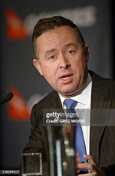 Qantas Group chief executive officer Alan Joyce announces company full year 2012/13 financial results in Sydney on August 29, 2013. Australian flag...