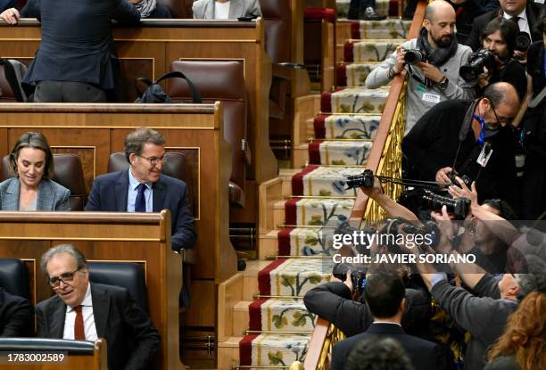 Partido Popular leader Alberto Nunez Feijoo looks at photographers prior a Parliamentary debate on the eve of a vote to elect Spain's next premier,...