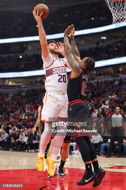 Jusuf Nurkic of the Phoenix Suns shoots over DeMar DeRozan of the Chicago Bulls during the first half at the United Center on November 08, 2023 in...