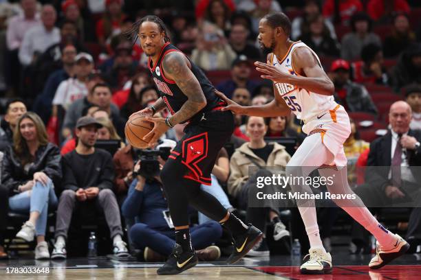 DeMar DeRozan of the Chicago Bulls is defended by Kevin Durant of the Phoenix Suns during the first half at the United Center on November 08, 2023 in...