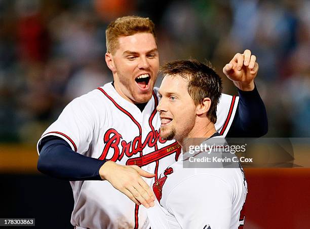 Chris Johnson of the Atlanta Braves celebrates with Freddie Freeman after hitting a walk-off RBI single in the ninth inning against the Cleveland...