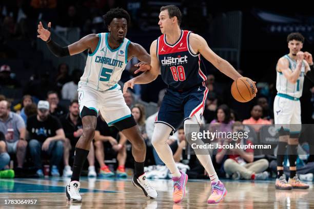 Mark Williams of the Charlotte Hornets guards Danilo Gallinari of the Washington Wizards in the third quarter during their game at Spectrum Center on...