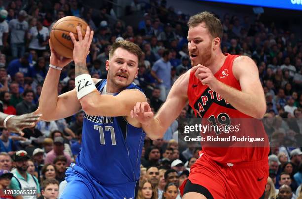 Luka Doncic of the Dallas Mavericks drives past Jakob Poeltl of the Toronto Raptors in the second quarter at American Airlines Center on November 08,...