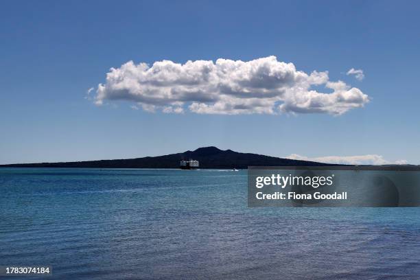 Ship passes in front of Rangitoto Island in the Waitemata Harbour on November 09, 2023 in Auckland, New Zealand. New Zealand voted in a general...