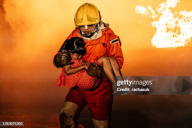 firefighter help and safety a little girl - fire rescue stock pictures, royalty-free photos & images