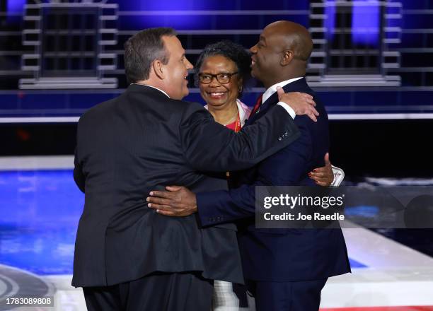 Republican presidential candidate U.S. Sen. Tim Scott embraces his mother Frances Scott and fellow candidate former New Jersey Gov. Chris Christie at...