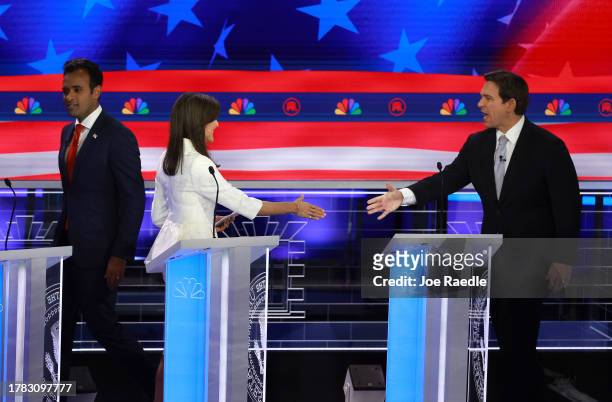 Republican presidential candidate former U.N. Ambassador Nikki Haley shakes hands with Florida Gov. Ron DeSantis as fellow candidate Vivek Ramaswamy...