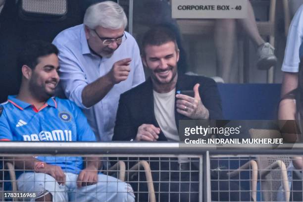Former English football player David Beckham along with Akash Ambani , the son of Reliance Industries billionaire Mukesh Ambani, watches the 2023 ICC...