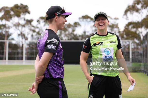 Heather Knight of the Thunder and Elyse Villani of the Hurricanes take part in the bat toss during the WBBL match between Sydney Thunder and Hobart...
