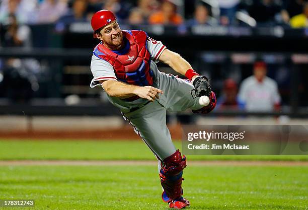 Erik Kratz of the Philadelphia Phillies throws out a New York Mets batter in the third inning at Citi Field on August 27, 2013 in the Flushing...