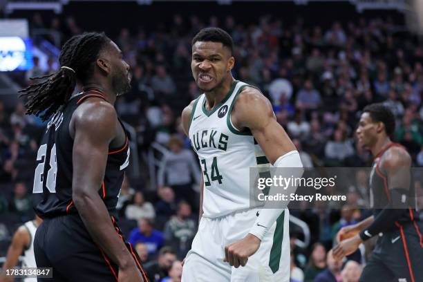 Giannis Antetokounmpo of the Milwaukee Bucks reacts to a score in front of Isaiah Stewart of the Detroit Pistons during the second half of a game...