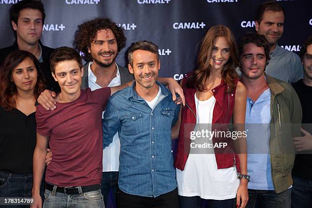 Yann Barthes with his team during a photocall for French TV Canal+ new season's launching evening on August 28, 2013 in Paris. AFP PHOTO / THOMAS...