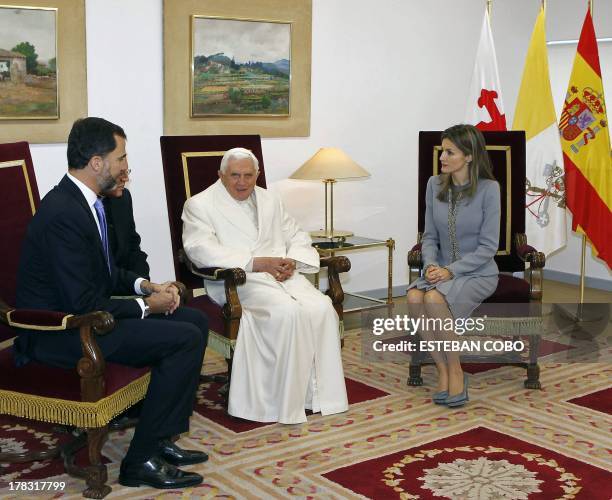 Pope Benedict XVI chats with Spain's Prince Felipe and Spain's Princess Letizia upon his arrival at Lavacolla airport in Santiago de Compostela, on...