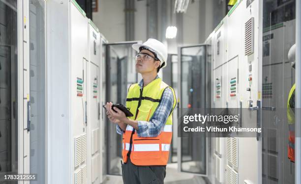 electrician engineer and tablet working at electrical room - schaltschrank stock-fotos und bilder