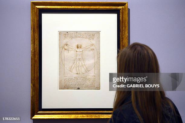 Woman looks at the "Vitruvian Man" a drawing by Leonardo da Vinci, on August 2ç, 2013 in Venice. Fifty-two drawings by Renaissance genius Leonardo da...