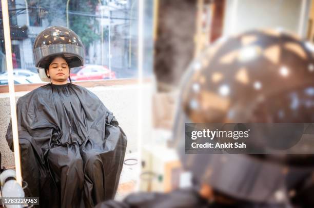 woman getting hair treatment under a professional hair steamer in salon - hair steamer stock pictures, royalty-free photos & images