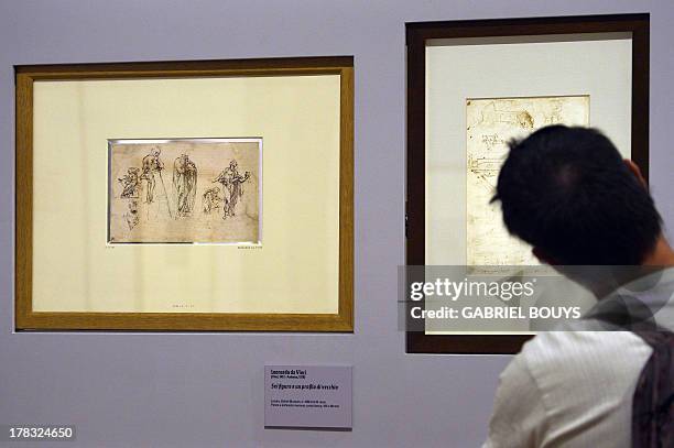 Man looks at drawings by Leonardo da Vinci, on August 29, 2013 in Venice. Fifty-two drawings by Renaissance genius Leonardo da Vinci are going on...