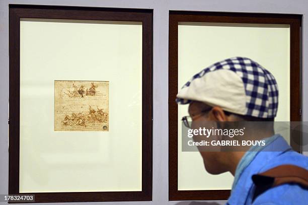 Man looks at a drawing by Leonardo da Vinci, on August 29, 2013 in Venice. Fifty-two drawings by Renaissance genius Leonardo da Vinci are going on...