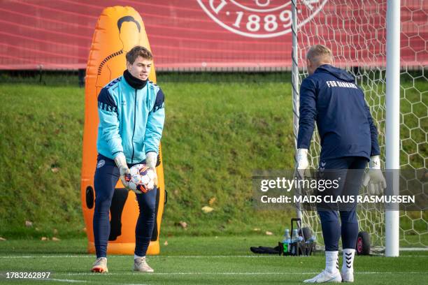 Danish goalkeepers Mads Hermansen and Kasper Schmeichel attend a training session on November 15, 2023 in Helsingor, Denmark, as the team prepares...