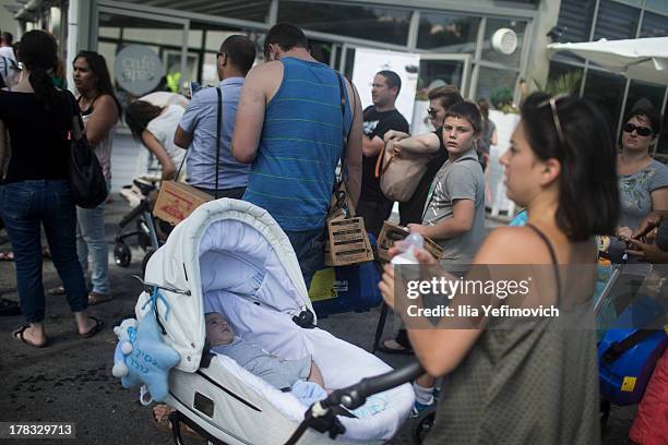 Israeli citizens gather in the city of Haifa to change and pick up gas masks as tension surrounding the Syrian crisis escalates on August 29, 2013 in...