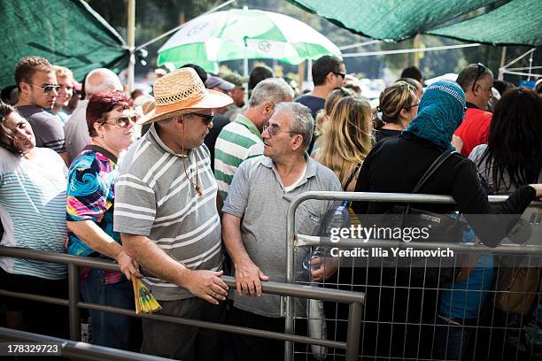 Israeli citizens gather in the city of Haifa to change and pick up gas masks as tension surrounding the Syrian crisis escalates on August 29, 2013 in...