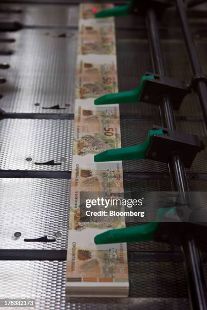 Real bills are produced at the Casa da Moeda, Brazil's national mint, in Rio de Janeiro, Brazil, on Wednesday, Aug. 28 , 2013. With the real falling...