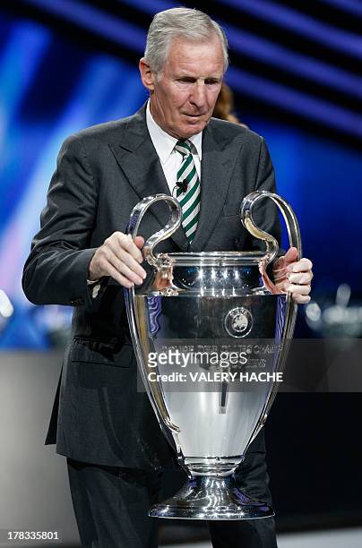 Scottish former football player Billy McNeill arrives with the Champions League trophy during the UEFA 2013/2014 Champions League group stage draw,...