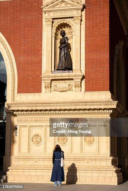 Artist Poppy Field in front of the bronze sculptures of the late Queen Elizabeth she created at Royal Albert Hall on November 15, 2023 in London,...