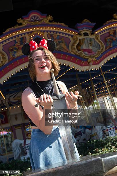 In this handout photo provided by Disney Parks, actress Maisie Williams, who portrays Arya Stark on the HBO series "Game of Thrones," pulls the sword...