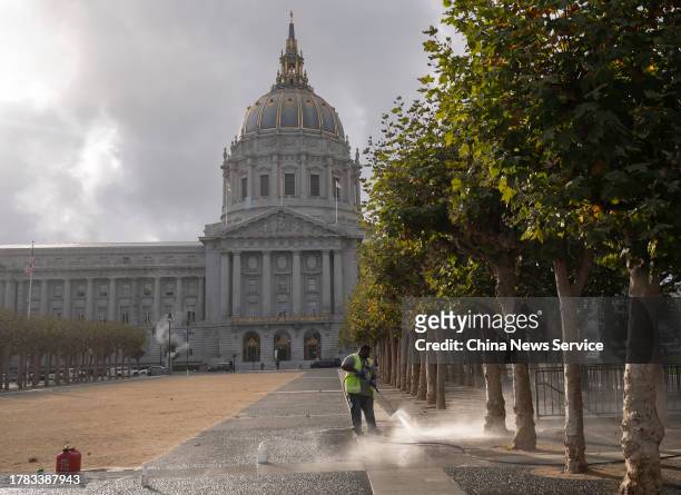 Sanitation worker cleans street in front of San Francisco City Hall on November 6, 2023 in San Francisco, California.
