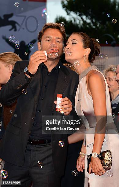 Alessio Vinci and Juliet Linley guests of Jaeger-LeCoultre create soap bubbles on the red carpet for the 'Emergency' charity at the 'Tracks' premiere...