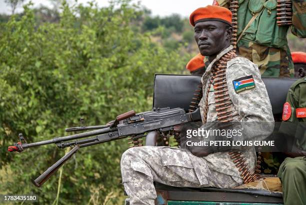 South Sudanese military police officer sits on a pickup truck while monitoring the area as troops belonging to the South Sudanese Unified Forces take...