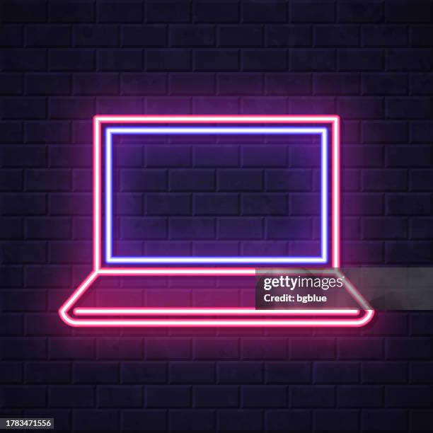 laptop. glowing neon icon on brick wall background - touch screen wall stock illustrations