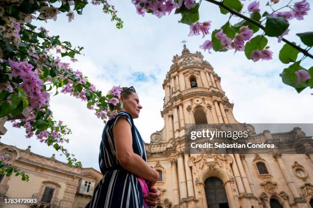 beautiful woman under the flower branch, visiting modica, sicily travel 2023. - modica sicily stock pictures, royalty-free photos & images