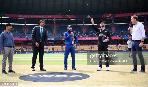 Kane Williamson of New Zealand flips the coin as Kusal Mendis of Sri Lanka looks on ahead of the ICC Men's Cricket World Cup India 2023 between New...
