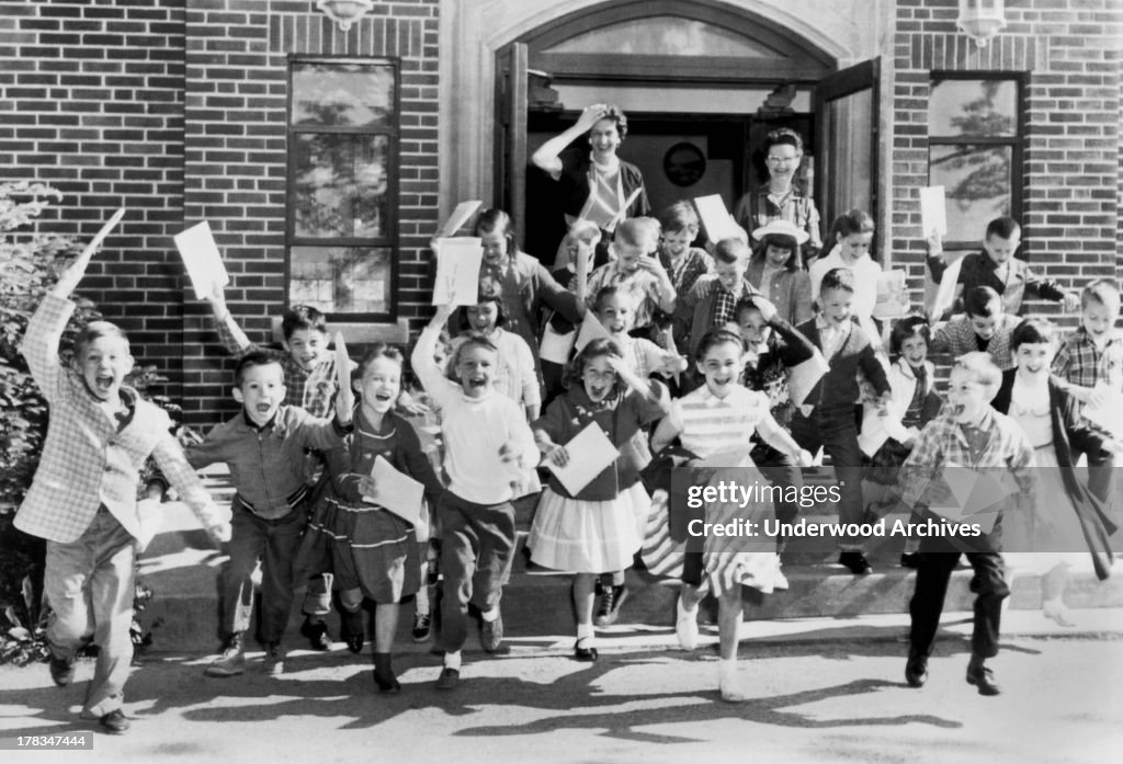 Second graders rush out the door on the last day of school while