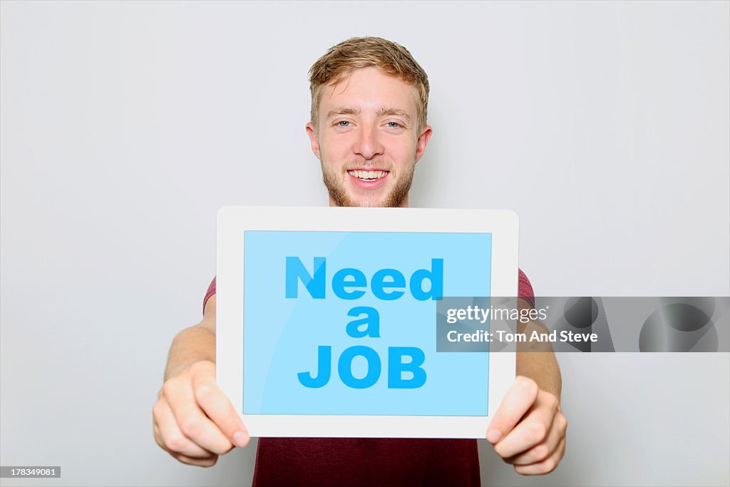 Job seeker holding sign on tablet computer