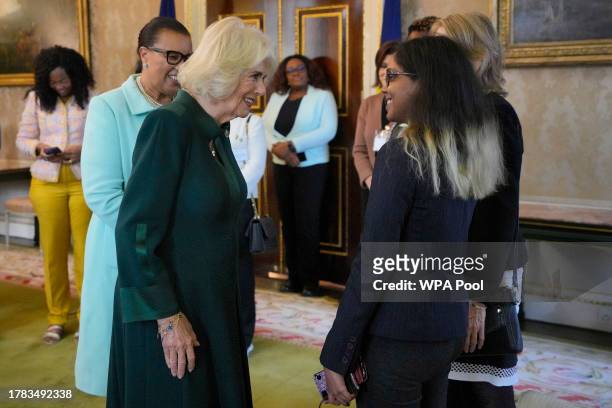 Queen Camilla speaks to Maya Kirti Nanan as she attends the Commonwealth Women Leader's event at Marlborough House on November 15, 2023 in London,...