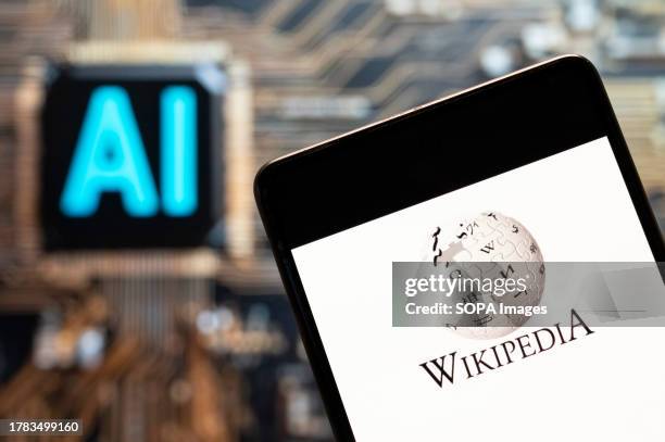 In this photo illustration, the multilingual, web-based, free encyclopedia Wikipedia logo seen displayed on a smartphone with an Artificial...