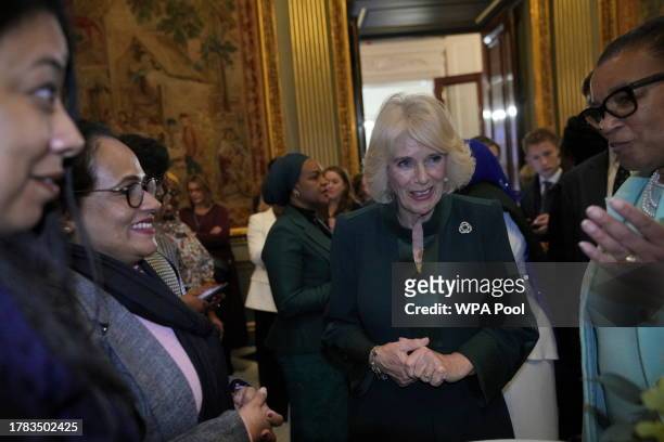 Queen Camilla talks to guests as she attends the Commonwealth Women Leader's event at Marlborough House on November 15, 2023 in London, England. The...