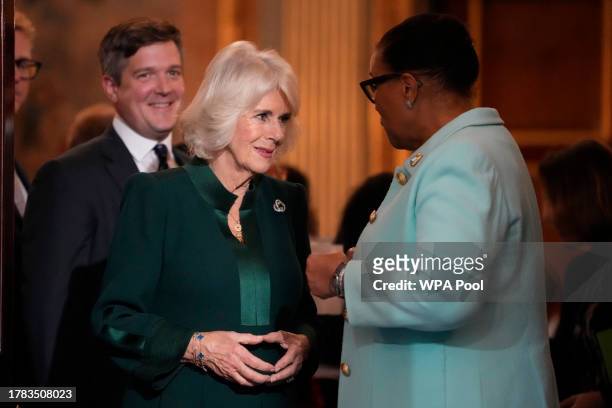 Queen Camilla speaks to Patricia Scotland, Baroness Scotland as they attend the Commonwealth Women Leader's event at Marlborough House on November...