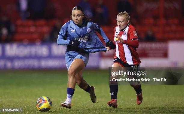 Ebony Salmon of Aston Villa runs past Alanta Brown of Sheffield United during the FA Women's Continental Tyres League Cup match between Sheffield...