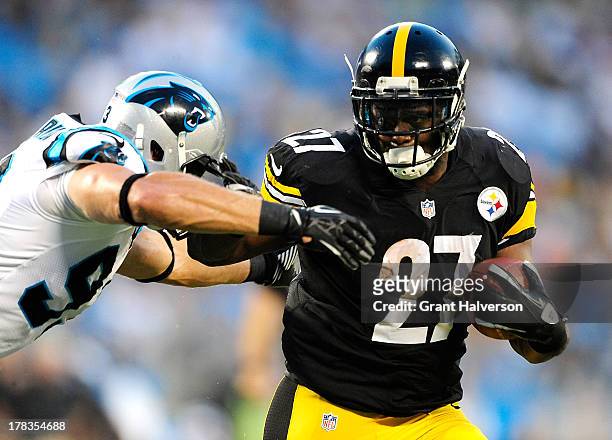 Jonathan Dwyer of the Pittsburgh Steelers stiff-arms Chase Blackburn of the Carolina Panthers during a preseason NFL game at Bank of America Stadium...
