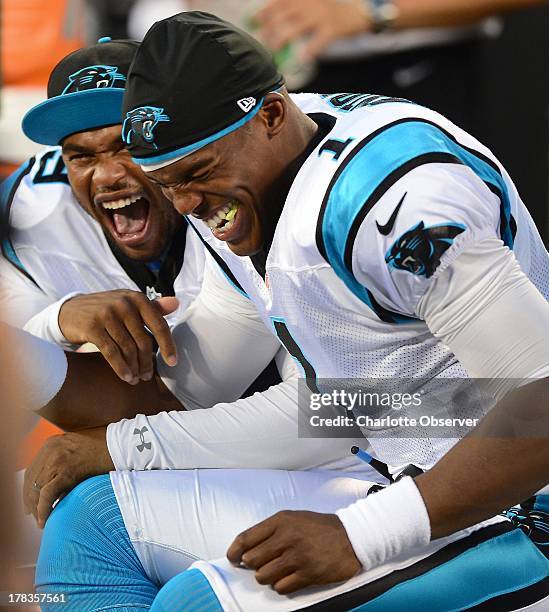 Carolina Panthers wide receiver Steve Smith, left, and quarterback Cam Newton laugh together on the team's bench during first-quarter action in a...