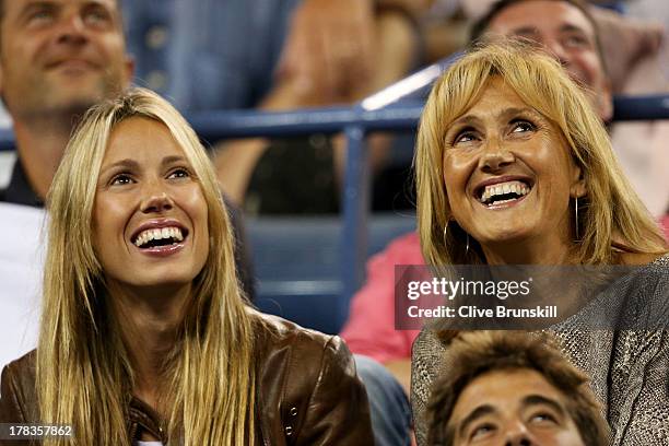 Rafael Nadal of Spain's sister Isabel Nadal and mother Ana Maria Parera laugh during his men's singles second round match against Rogerio Dutra Silva...