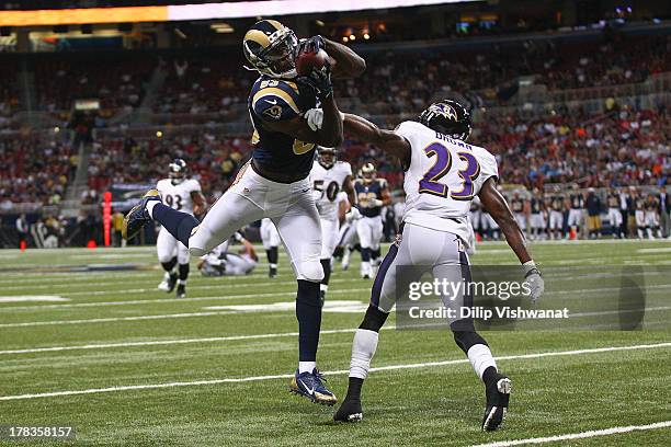 Brian Quick of the St. Louis Rams catches a pass against Chykie Brown of the Baltimore Ravens during a pre-season game at the Edward Jones Dome on...